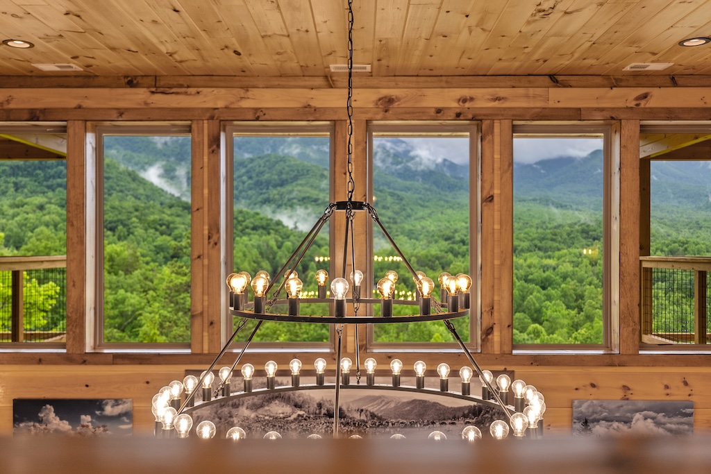 Cabin great room with chandelier and mountain views