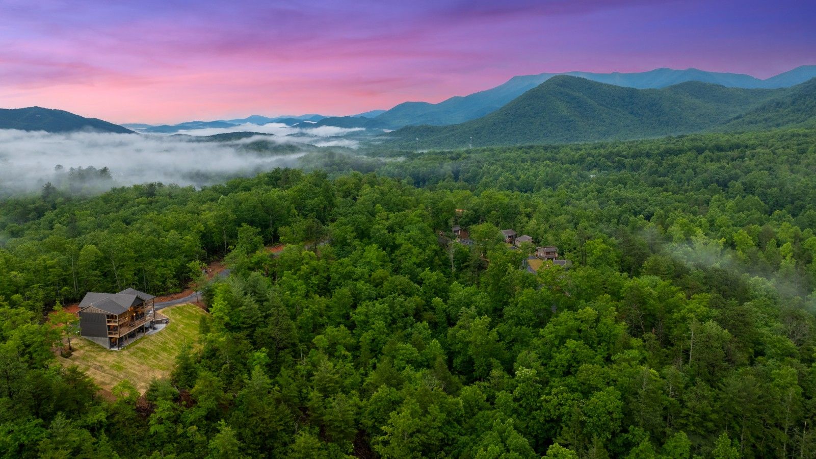 Aerial view of King Pool Cabin surrounded by mountains