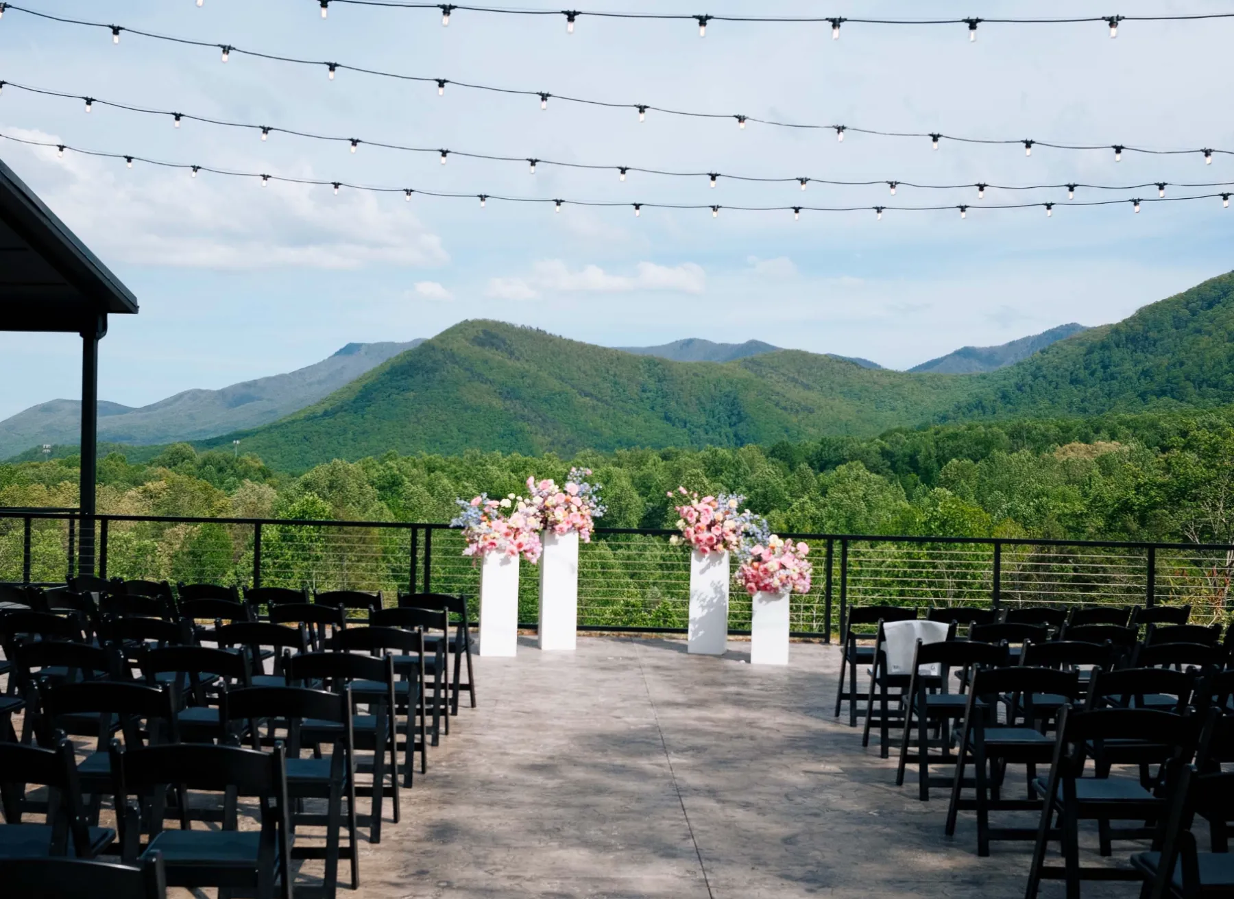 Ceremony deck set with chairs and florals overlooking the Smoky Mountains